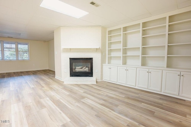 10 Marchmont Ct, Durham, NC 27705 - unfurnished living room with light wood-style floors and a fireplace