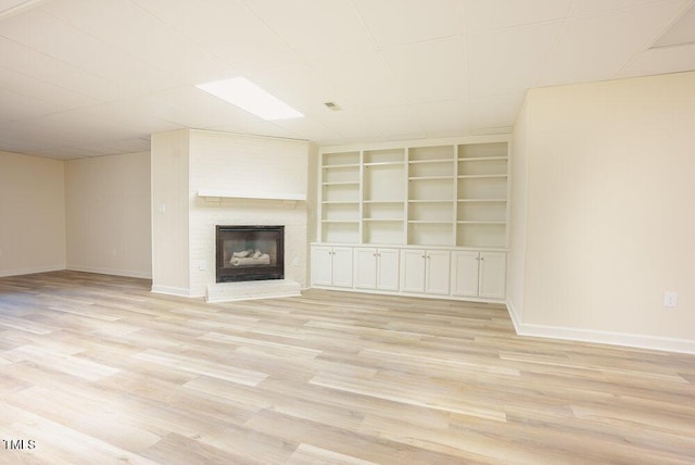 10 Marchmont Ct, Durham, NC 27705 - unfurnished living room featuring a brick fireplace, light wood finished floors, and built in shelves