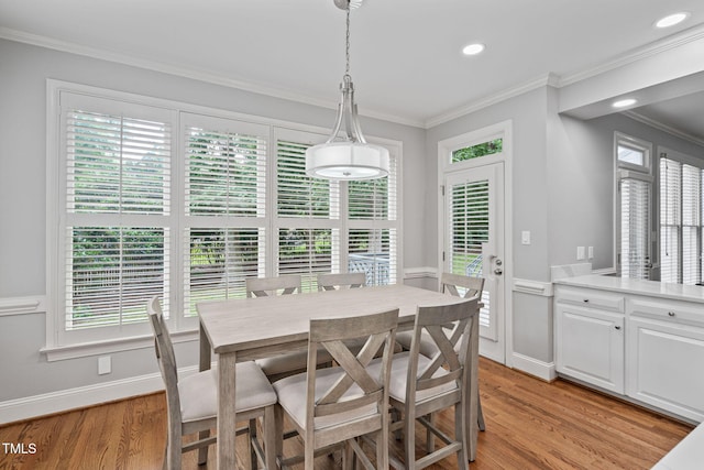 202 Stoneleigh Dr, Cary, NC 27511 - dining space with crown molding, light wood-style flooring, healthy amount of natural light, recessed lighting, and a wainscoted wall