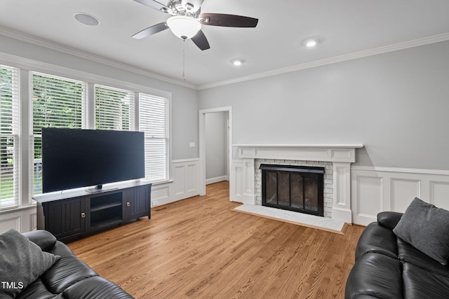 202 Stoneleigh Dr, Cary, NC 27511 - living area featuring healthy amount of natural light, crown molding, ceiling fan, a decorative wall, and a brick fireplace