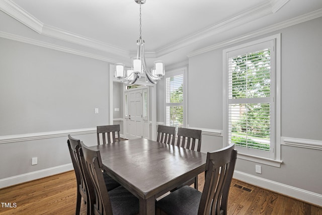 202 Stoneleigh Dr, Cary, NC 27511 - dining area featuring a chandelier, wood finished floors, and ornamental molding