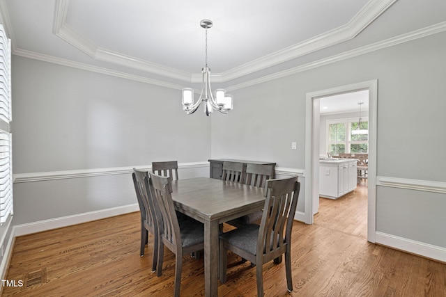 202 Stoneleigh Dr, Cary, NC 27511 - dining space with a chandelier, light wood finished floors, and ornamental molding