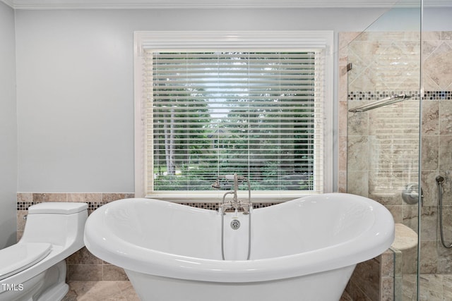 202 Stoneleigh Dr, Cary, NC 27511 - bathroom with tile walls, a freestanding tub, tiled shower, ornamental molding, and wainscoting