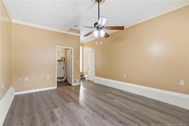 3820 Crusader Dr, Hope Mills, NC 28348 - unfurnished bedroom with wood finished floors, crown molding, a walk in closet, and a ceiling fan