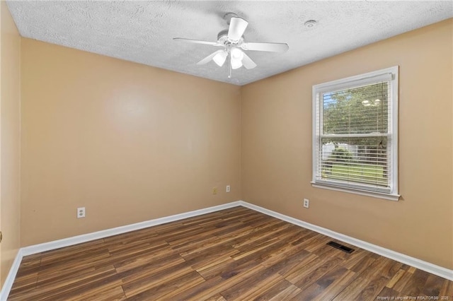 3820 Crusader Dr, Hope Mills, NC 28348 - unfurnished room with dark wood-style floors, a textured ceiling, and ceiling fan