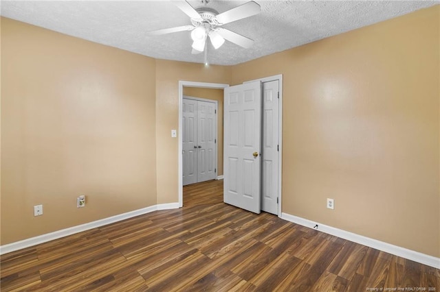 3820 Crusader Dr, Hope Mills, NC 28348 - unfurnished bedroom with dark wood-style flooring, a textured ceiling, and a ceiling fan