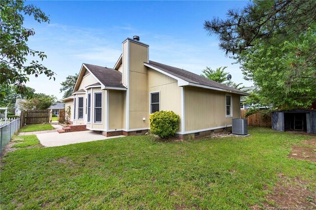 3820 Crusader Dr, Hope Mills, NC 28348 - rear view of house featuring crawl space, a fenced backyard, a chimney, and a storage unit