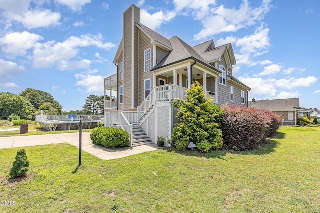 656 Atkins Rd, Fuquay Varina, NC 27526 - view of front of house featuring a front yard, stairs, covered porch, concrete driveway, and a chimney