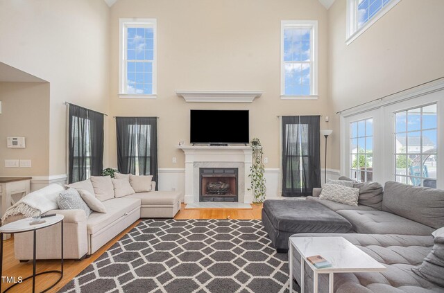 656 Atkins Rd, Fuquay Varina, NC 27526 - living room with a high ceiling, wood finished floors, healthy amount of natural light, and a fireplace with flush hearth