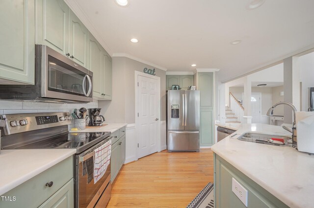 656 Atkins Rd, Fuquay Varina, NC 27526 - kitchen featuring stainless steel appliances, green cabinets, light countertops, recessed lighting, and crown molding