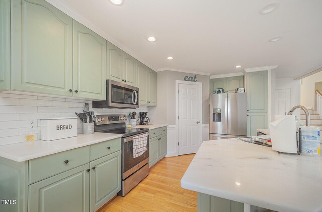656 Atkins Rd, Fuquay Varina, NC 27526 - kitchen featuring stainless steel appliances, green cabinetry, decorative backsplash, light countertops, and recessed lighting