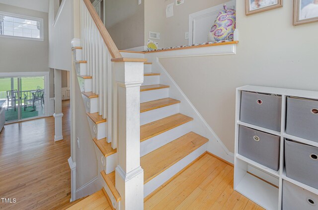656 Atkins Rd, Fuquay Varina, NC 27526 - staircase with wood finished floors, plenty of natural light, and a high ceiling