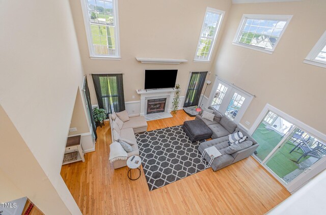 656 Atkins Rd, Fuquay Varina, NC 27526 - living room with a high ceiling, wood finished floors, healthy amount of natural light, and a fireplace with flush hearth