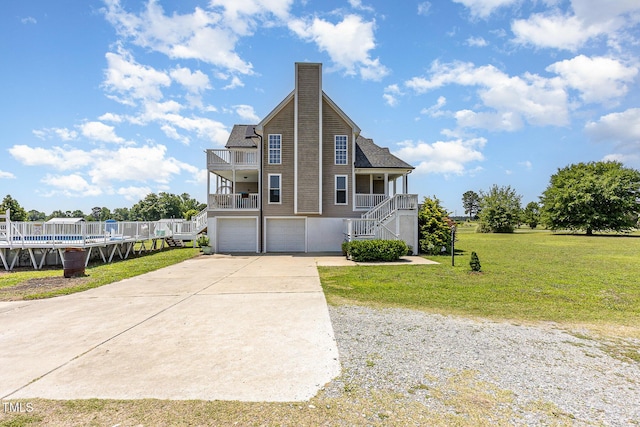 656 Atkins Rd, Fuquay Varina, NC 27526 - view of front of home with stairs, a garage, a chimney, a front lawn, and concrete driveway