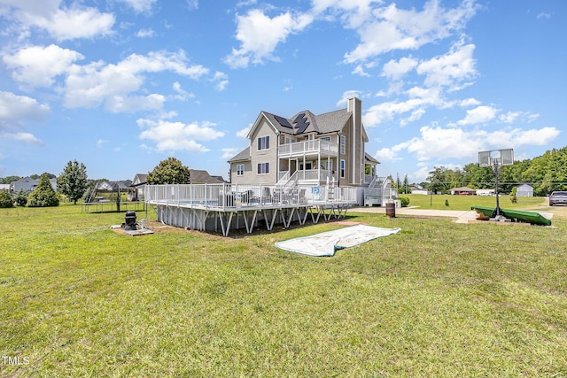 656 Atkins Rd, Fuquay Varina, NC 27526 - back of house with a balcony, stairway, a chimney, and a lawn