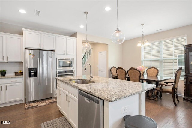 1416 Southpoint Trl, Durham, NC 27713 - kitchen featuring stainless steel appliances, white cabinets, dark wood finished floors, decorative light fixtures, and recessed lighting