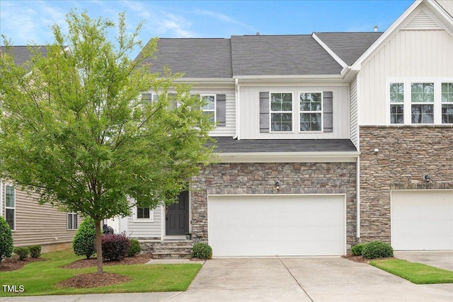 1416 Southpoint Trl, Durham, NC 27713 - townhome / multi-family property with stone siding, board and batten siding, concrete driveway, and an attached garage