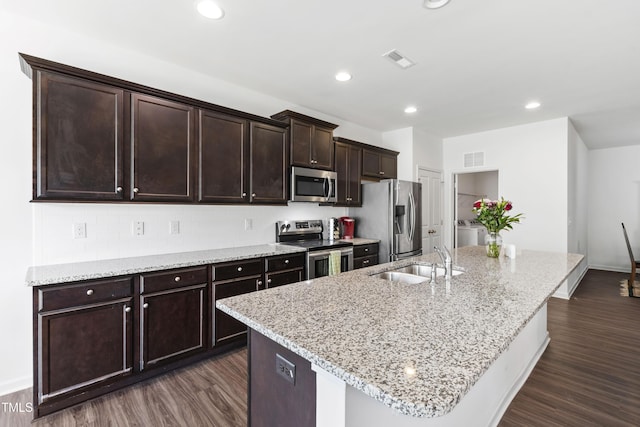 202 E Painted Way, Clayton, NC 27527 - kitchen featuring stainless steel appliances, an island with sink, dark wood-style flooring, dark brown cabinets, and recessed lighting
