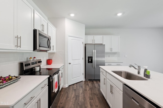 248 Hawksmoore Ln, Lillington, NC 27546 - kitchen with appliances with stainless steel finishes, dark wood-style flooring, white cabinetry, tasteful backsplash, and light countertops