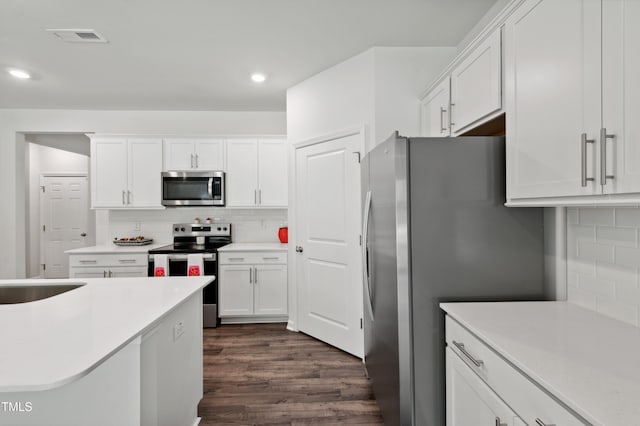 248 Hawksmoore Ln, Lillington, NC 27546 - kitchen featuring stainless steel appliances, tasteful backsplash, white cabinetry, and recessed lighting