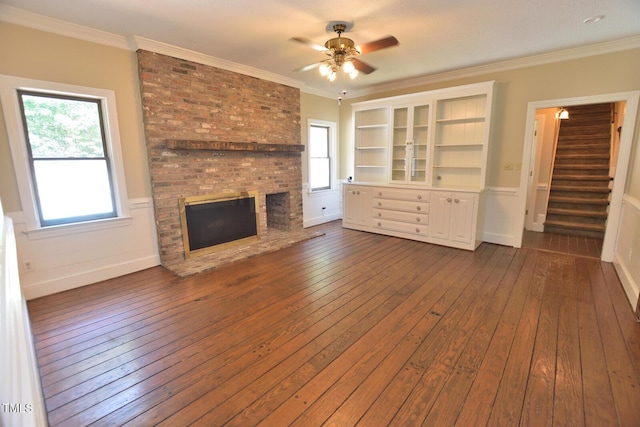 2708 Coleberry Trl, Rocky Mount, NC 27804 - unfurnished living room with a fireplace, stairs, dark wood-type flooring, a ceiling fan, and crown molding