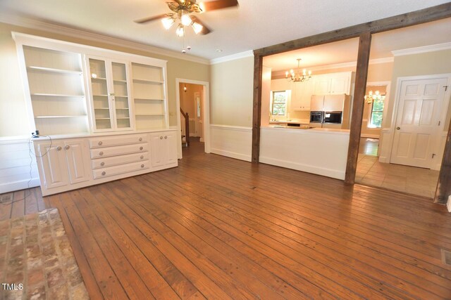 2708 Coleberry Trl, Rocky Mount, NC 27804 - unfurnished living room with a chandelier, dark wood finished floors, a ceiling fan, ornamental molding, and wainscoting