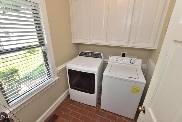 2708 Coleberry Trl, Rocky Mount, NC 27804 - washroom featuring washer and clothes dryer, cabinet space, plenty of natural light, and brick patterned flooring