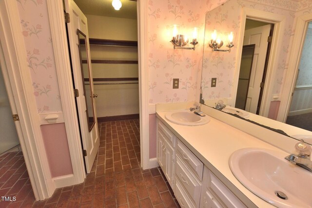 2708 Coleberry Trl, Rocky Mount, NC 27804 - full bathroom featuring brick patterned floors, wallpapered walls, and double vanity