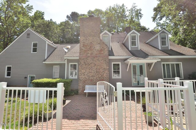 2708 Coleberry Trl, Rocky Mount, NC 27804 - back of property with a chimney, a wooden deck, and roof with shingles