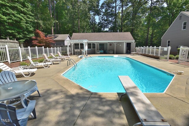 2708 Coleberry Trl, Rocky Mount, NC 27804 - view of swimming pool with a patio, a storage structure, an outdoor structure, a diving board, and view of scattered trees