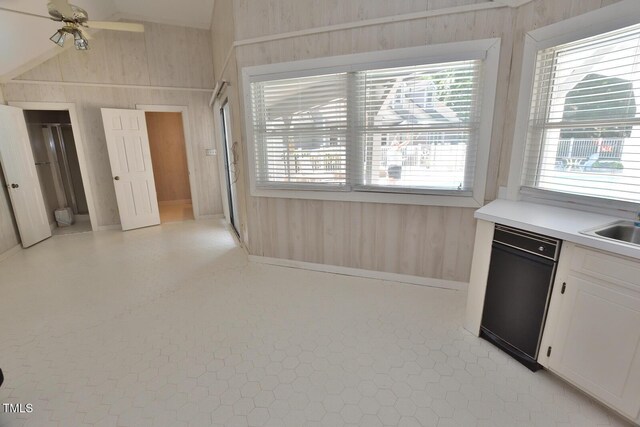 2708 Coleberry Trl, Rocky Mount, NC 27804 - kitchen featuring dishwasher, wooden walls, vaulted ceiling, ceiling fan, and white cabinets