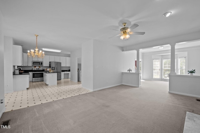 8 Summertime Ct, Durham, NC 27707 - kitchen with appliances with stainless steel finishes, dark countertops, open floor plan, and light carpet
