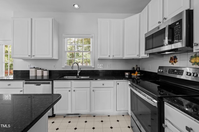 8 Summertime Ct, Durham, NC 27707 - kitchen with appliances with stainless steel finishes, white cabinets, recessed lighting, and dark stone countertops