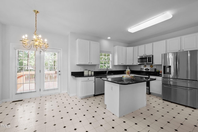 8 Summertime Ct, Durham, NC 27707 - kitchen featuring stainless steel appliances, a chandelier, white cabinets, light flooring, and recessed lighting