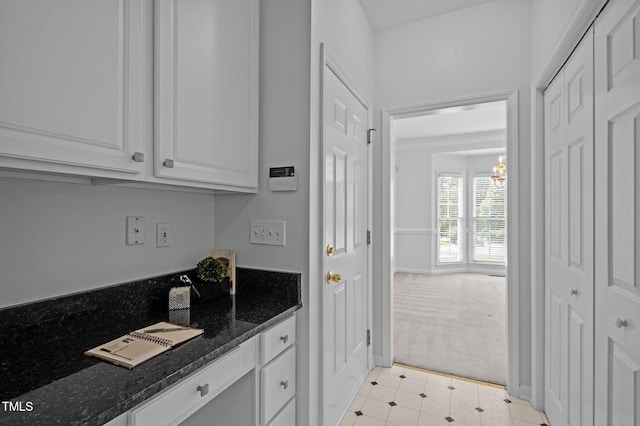 8 Summertime Ct, Durham, NC 27707 - kitchen featuring light colored carpet, white cabinets, dark stone counters, and a chandelier