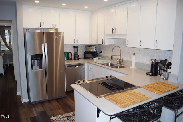 80 Stoneridge Rd, Durham, NC 27705 - kitchen featuring stainless steel appliances, light countertops, dark wood finished floors, white cabinets, and recessed lighting