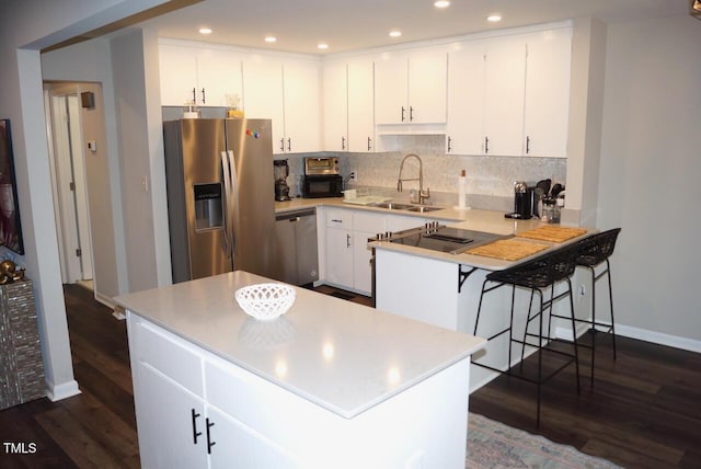 80 Stoneridge Rd, Durham, NC 27705 - kitchen featuring appliances with stainless steel finishes, dark wood-style floors, decorative backsplash, light countertops, and recessed lighting