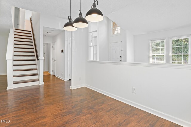 613 Penncross Dr, Raleigh, NC 27610 - unfurnished dining area with stairway, wood finished floors, and lofted ceiling
