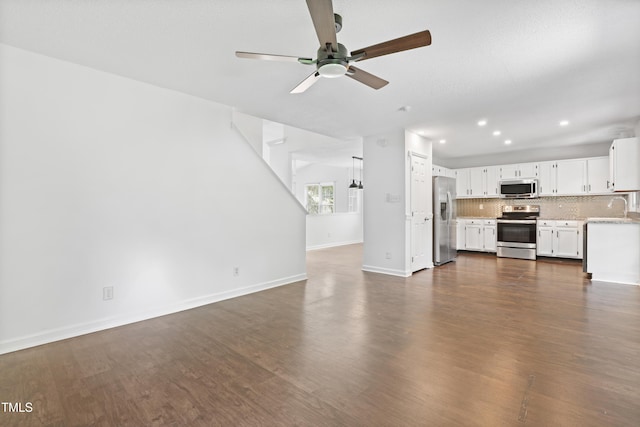 613 Penncross Dr, Raleigh, NC 27610 - unfurnished living room with a ceiling fan, dark wood-style floors, and recessed lighting