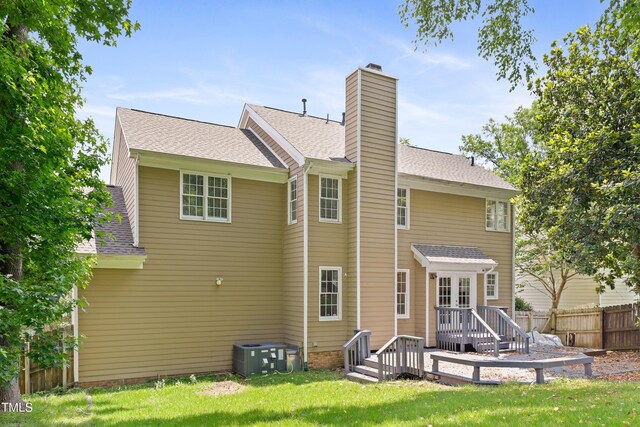 613 Penncross Dr, Raleigh, NC 27610 - back of property with a chimney, a shingled roof, and a wooden deck