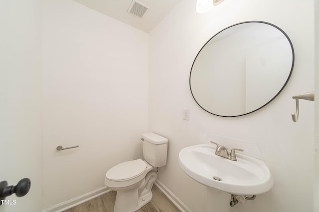 4258 Kaplan Dr, Raleigh, NC 27606 - bathroom featuring wood finished floors and toilet
