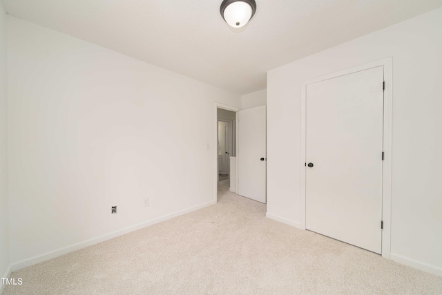 4258 Kaplan Dr, Raleigh, NC 27606 - unfurnished bedroom featuring light carpet and baseboards