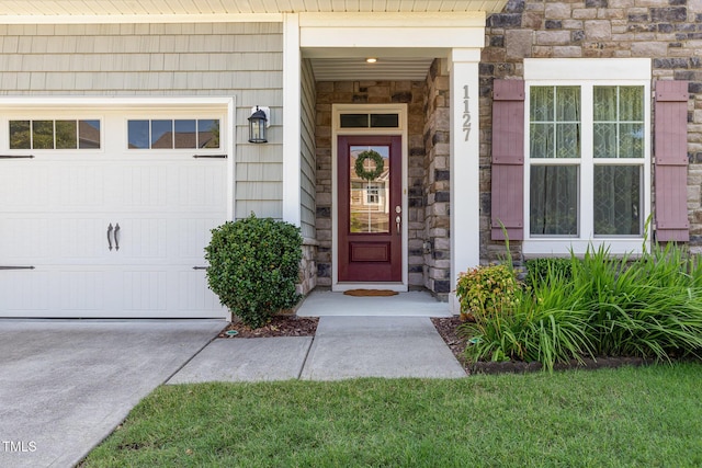 1127 Timbercut Dr, Durham, NC 27703 - view of exterior entry featuring stone siding and an attached garage