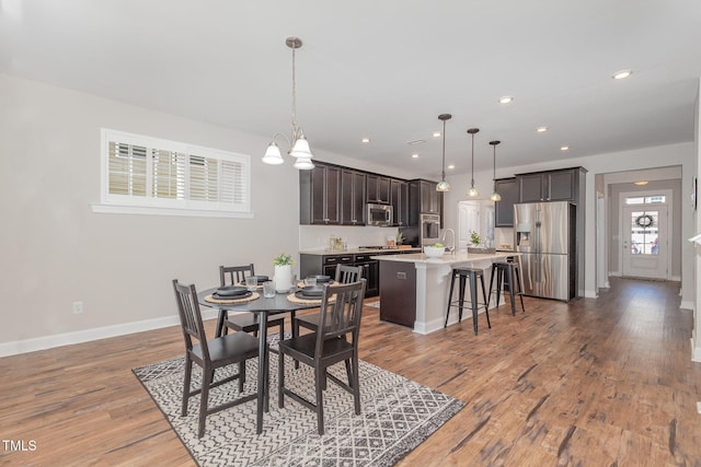 1127 Timbercut Dr, Durham, NC 27703 - dining area featuring light wood-style floors, a chandelier, and recessed lighting