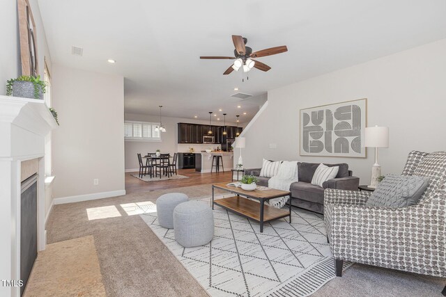 1127 Timbercut Dr, Durham, NC 27703 - living area featuring a ceiling fan, a fireplace with flush hearth, and recessed lighting