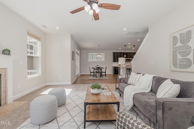 1127 Timbercut Dr, Durham, NC 27703 - living area with a ceiling fan, a premium fireplace, recessed lighting, and a chandelier