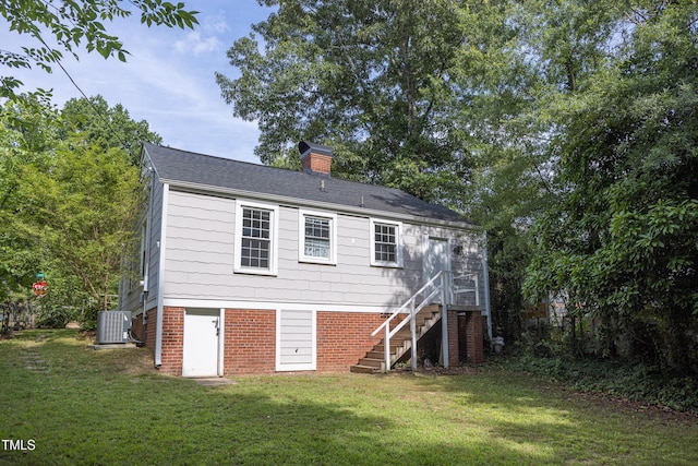 2423 Farthing St, Durham, NC 27704 - back of property featuring a lawn, stairway, and a chimney