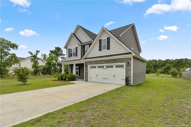 3902 Standardbred Dr, Hope Mills, NC 28348 - view of front of house with driveway, stone siding, a front lawn, and an attached garage
