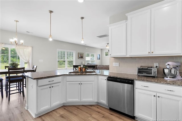 3902 Standardbred Dr, Hope Mills, NC 28348 - kitchen with stainless steel dishwasher, a peninsula, light wood-type flooring, and white cabinets