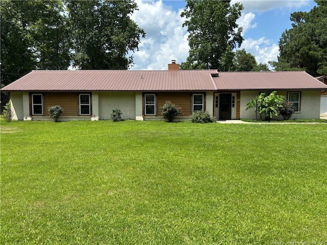 5200 Pineview Rd, Lumberton, NC 28360 - single story home with stucco siding, a metal roof, and a front lawn